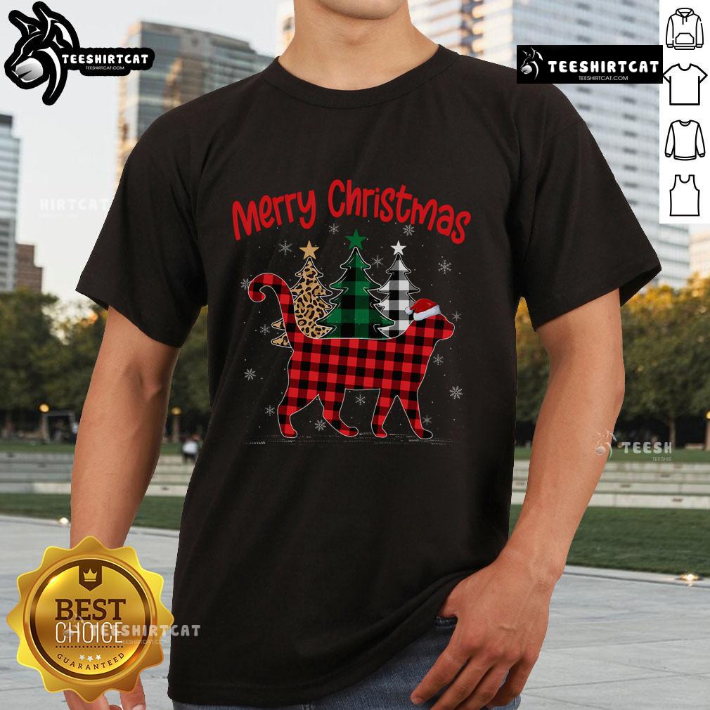Adorable cat in a Buffalo plaid Christmas pajama t-shirt near a decorated Xmas tree, perfect for holiday festivities.