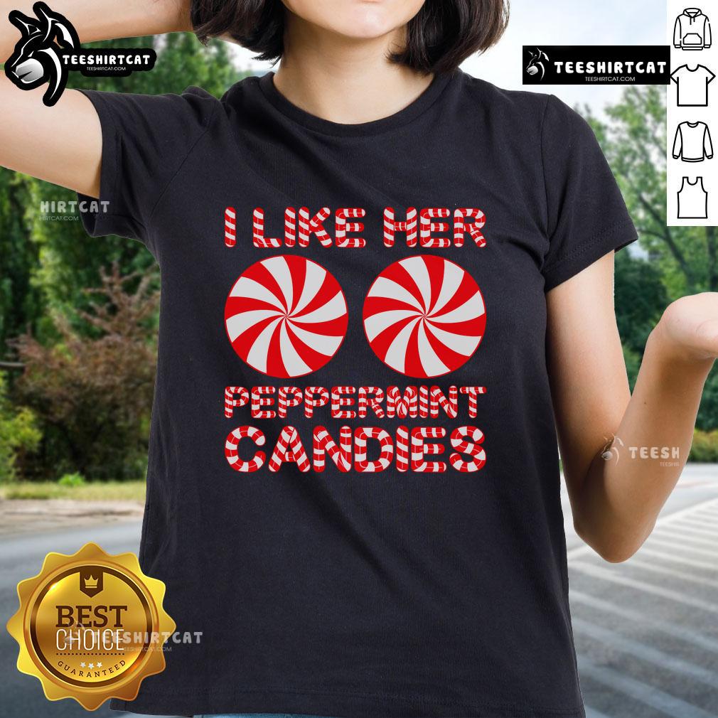 Couple in matching 'I Like Her Peppermint Candies' Christmas tees, celebrating the festive season together.