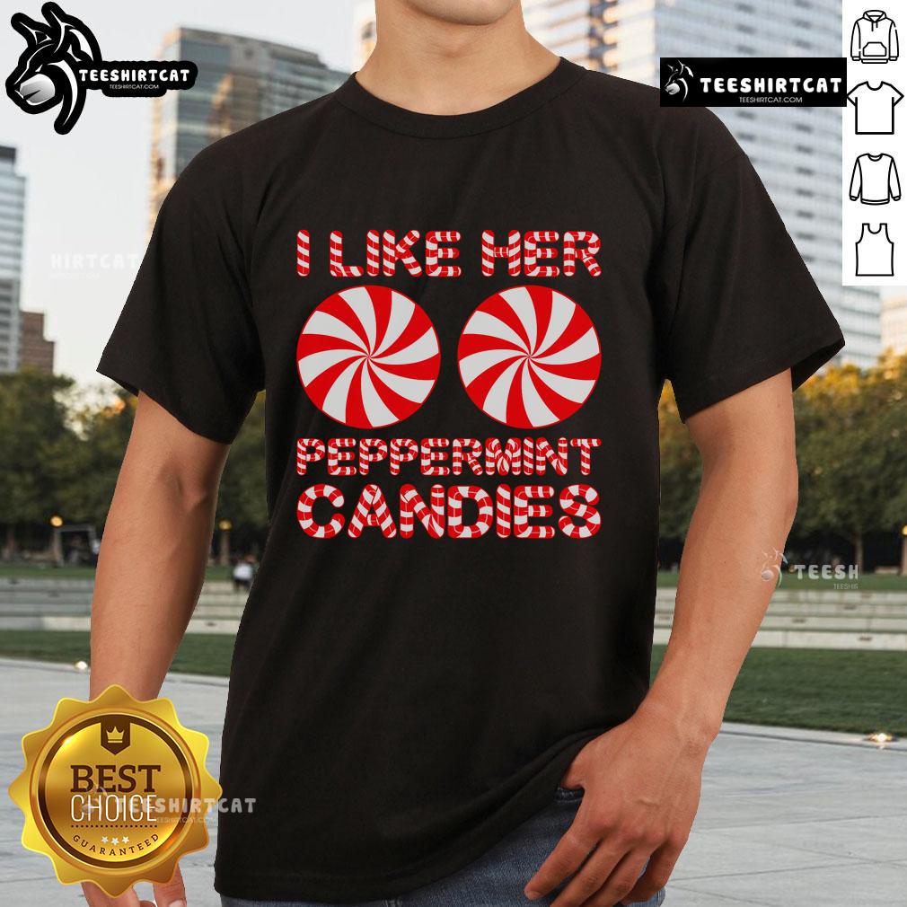 Christmas couple wearing matching 'I Like Her Peppermint Candies' T-shirts, festive holiday spirit and style.