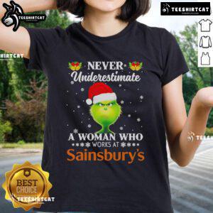 Festive women's tee featuring the Grinch and the quote 'Never underestimate a woman who works at Sainsbury's' for Christmas.