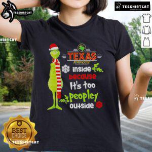 Inside Texas Roadhouse, festive Christmas decor with ladies wearing Grinch tees, ideal for holiday gatherings.