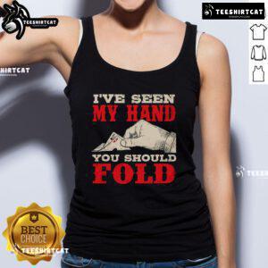 Poker card player in a tank top folds hand at casino, showcasing strategy and confidence in a thrilling game.