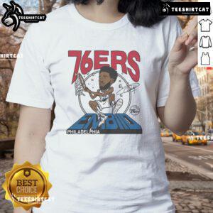 Alt Text: Official 76ers Joel Embiid Signature Ladies Tee in vibrant colors, perfect for fans of Philadelphia basketball.