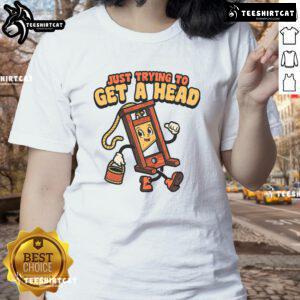 Funny guillotine graphic on a ladies tee, captioned 'Just Trying to Get a Head' for humorous fashion lovers.