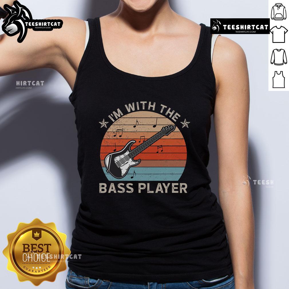 Sunset scene featuring a guitarist in a tank top, celebrating music joyfully with the bass player. Nice I'm with the Bass Player.