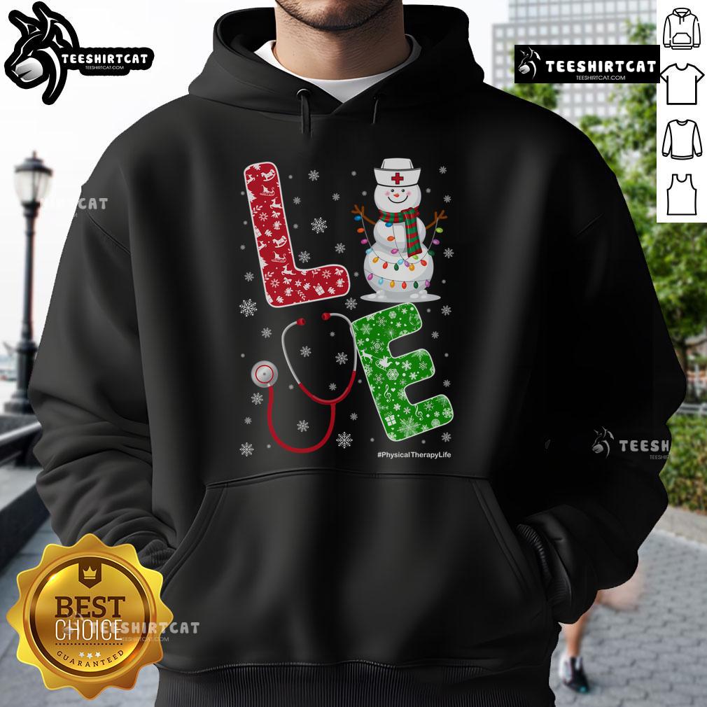 Cheerful nurse in a cozy hoodie enjoying Christmas snow, embodying the Nice Physical Therapy life.