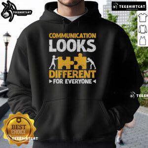 Autism teacher wearing a stylish hoodie with the phrase 'Communication Looks Different For Everyone' promoting inclusivity.
