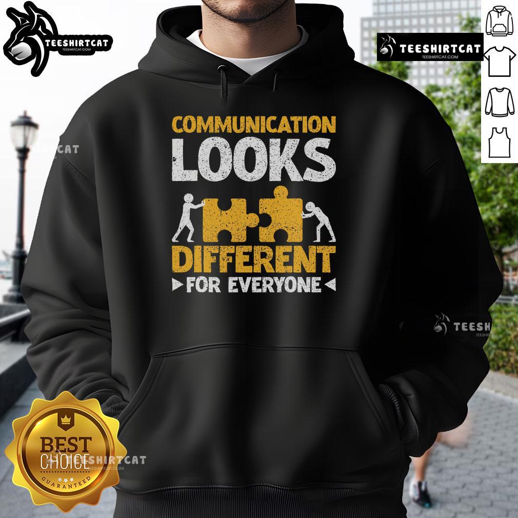 Autism teacher wearing a stylish hoodie with the phrase 'Communication Looks Different For Everyone' promoting inclusivity.