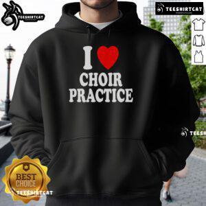 Choir members wearing 'I Heart Love' hoodies during practice, singing together in harmony at a vibrant rehearsal.