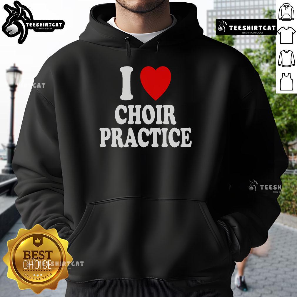 Choir members wearing 'I Heart Love' hoodies during practice, singing together in harmony at a vibrant rehearsal.