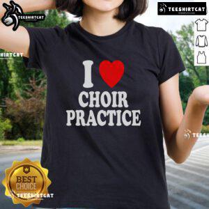 Alt Text: Ladies in 'I Heart Love Choir Practice' tees singing joyfully in chorus during a lively rehearsal session.