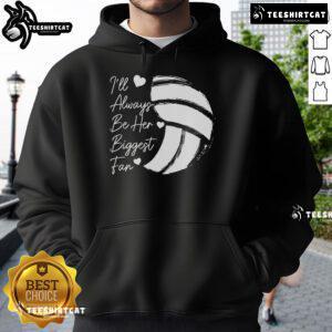Volleyball mom wearing a hoodie that says 'Her Biggest Fan,' showcasing support for her athlete in a vibrant setting.