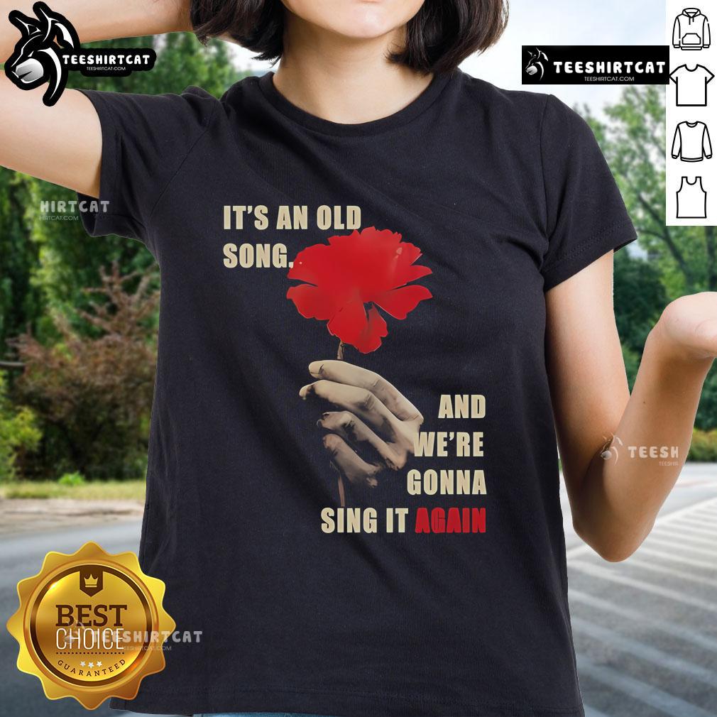 Official Hadestown 'It's an Old Song and We're Gonna Sing It Again' Ladies Tee featuring vibrant artwork and bold text.