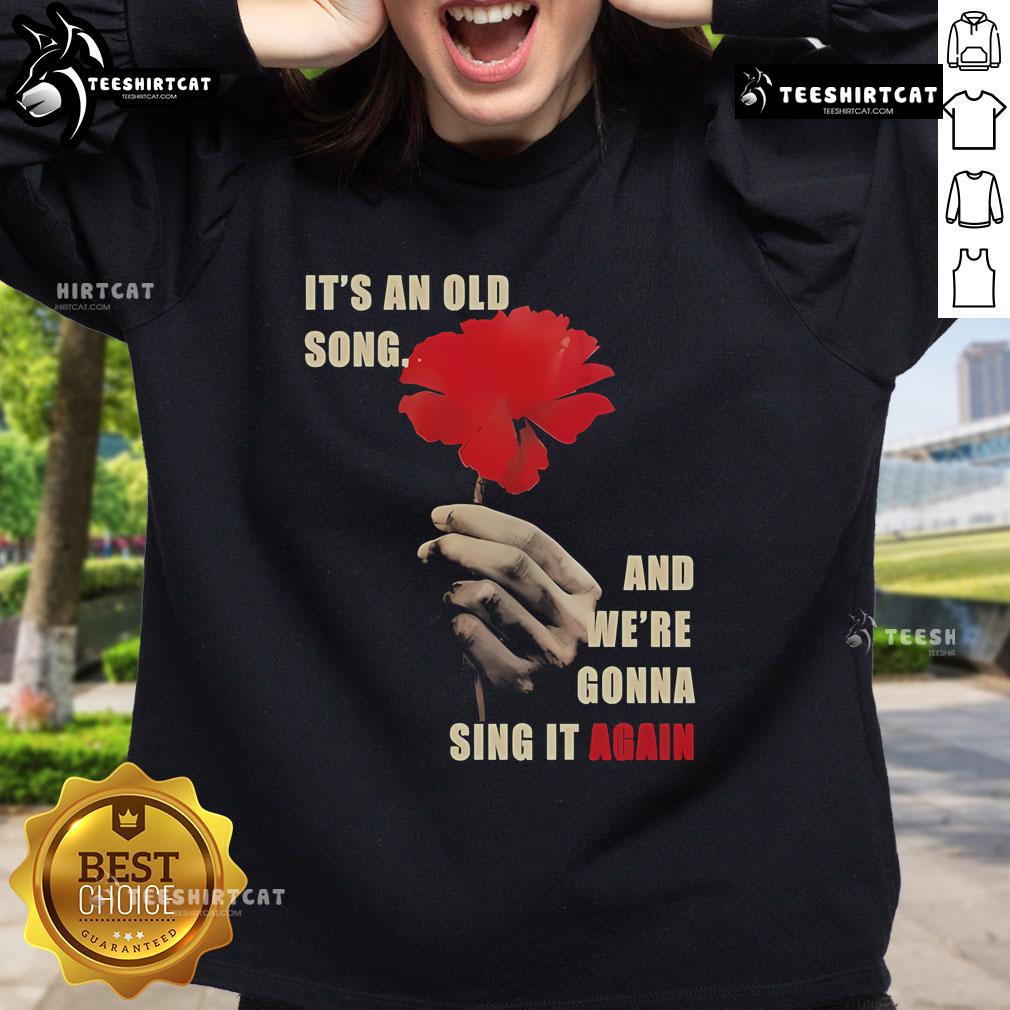 Alt Text: Hadestown Old Song sweatshirt featuring lyrics from 'It's An Old Song And We're Gonna Sing It Again' design.