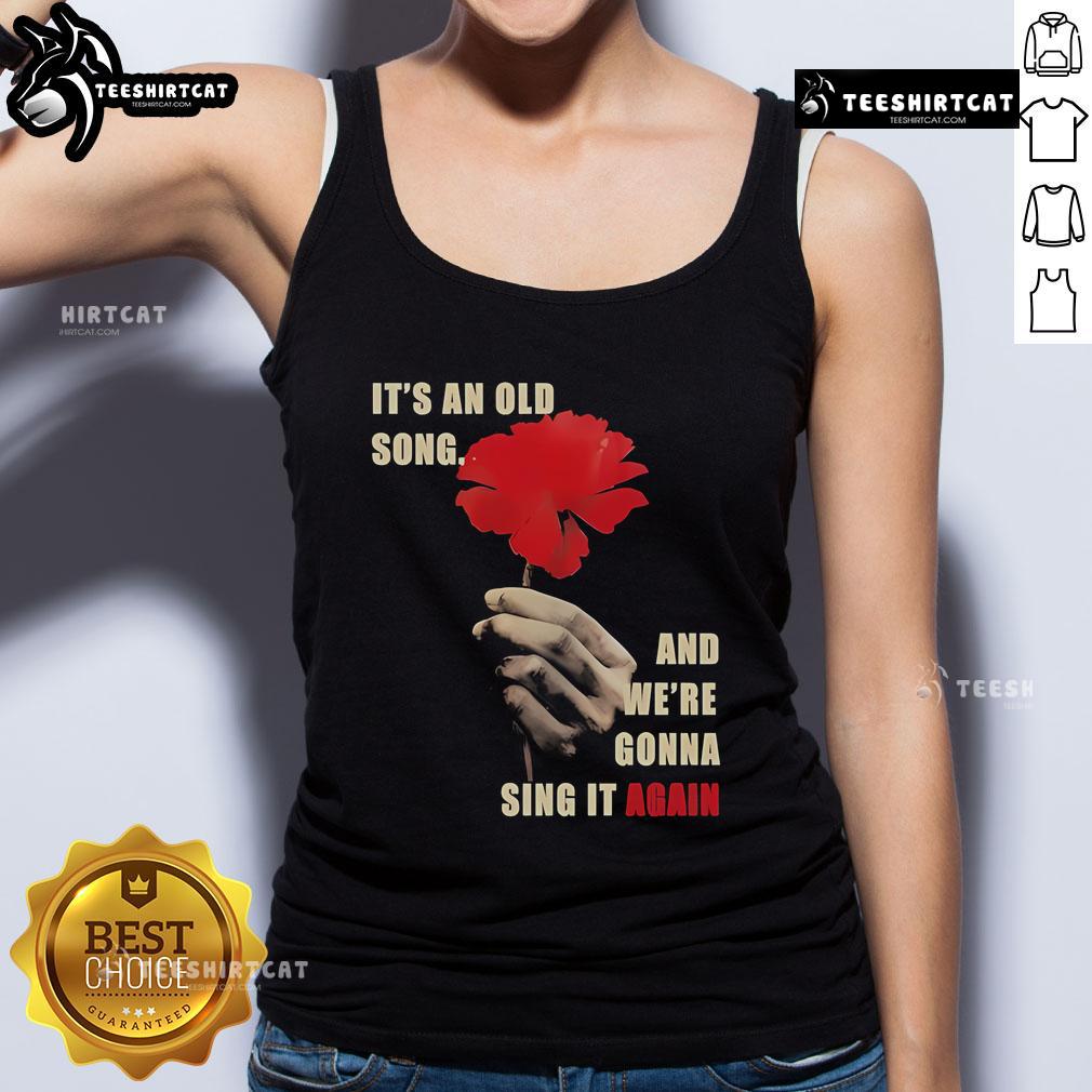 Woman wearing Hadestown 'Old Song' tank top, celebrating the iconic song from the musical in a vibrant setting.