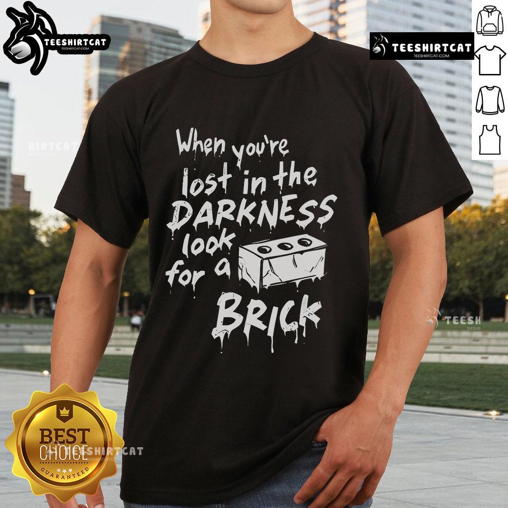 Official 'When You're Lost In The Darkness Look For A Brick' T-Shirt featuring a bold graphic design and stylish fit.