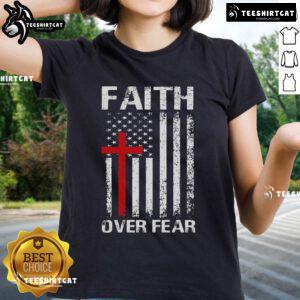 Top Christian USA flag ladies tee featuring 'Faith Over Fear' and a cross design, perfect for expressing faith.