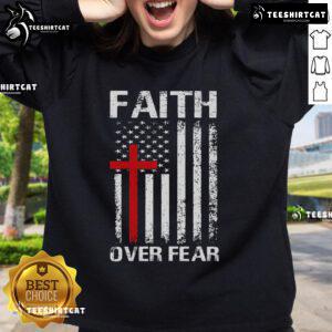Christian sweatshirt featuring USA flag and cross with 'Faith Over Fear' message, perfect for expressing faith in America.