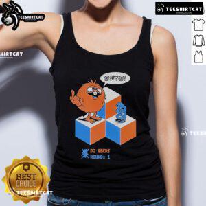 Top DJ Qbert showcases Round 1 X Morning Breath Club tank top design, featuring vibrant graphics and a stylish fit.