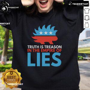 Stylish 'Top Truth Treason in the Empire of Lies' sweatshirt featuring bold text design on a cozy fabric background.