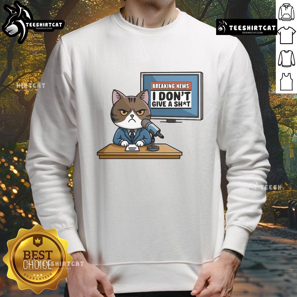 Alt Text: Funny Breaking News I Don't Give A Shit Angry Cat Sweatshirt design featuring a grumpy cat graphic.