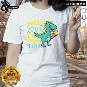 Lady wearing a Dino tee enjoying ice cream after tonsil removal, showcasing a fun and whimsical recovery moment.