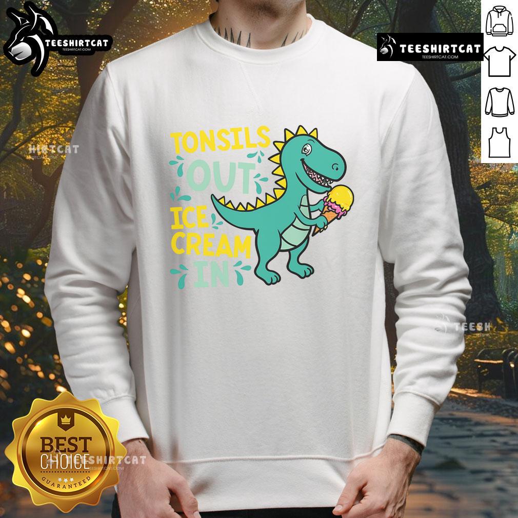 Child in a dinosaur sweatshirt enjoying ice cream after tonsil removal, showcasing a joyful recovery moment.