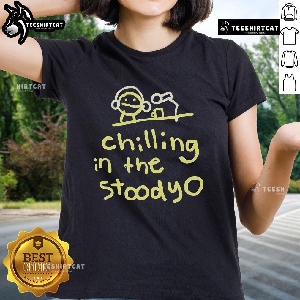 Official Mummy Joe chilling in the studio wearing a stylish ladies tee, showcasing a relaxed and trendy vibe.