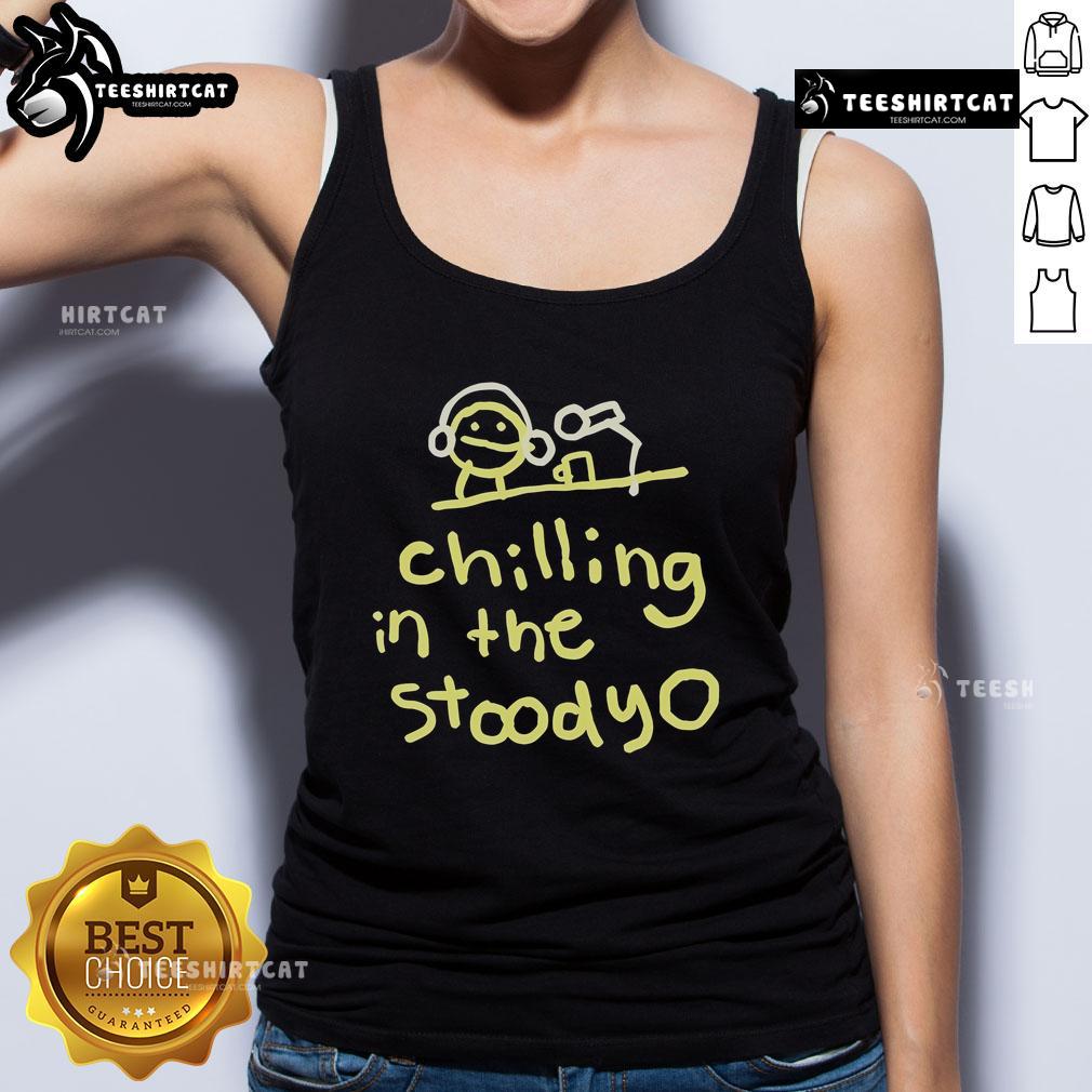 Alt Text: Official Mummy Joe relaxing in the studio, wearing a stylish tank top, exuding cool vibes and creativity.