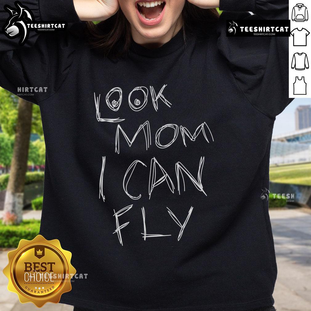 Child wearing a 'Pretty Look Mom I Can Fly' sweatshirt, smiling joyfully outdoors, showcasing playful style and comfort.
