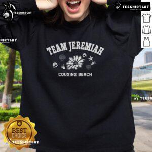Jeremiah wearing a 'The Summer I Turned Pretty' sweatshirt at the beach with friends, capturing a fun summer moment.