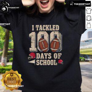 Boy wearing a 'Top 100 Days of School' football sweatshirt, celebrating the 100th day of school with festive spirit.