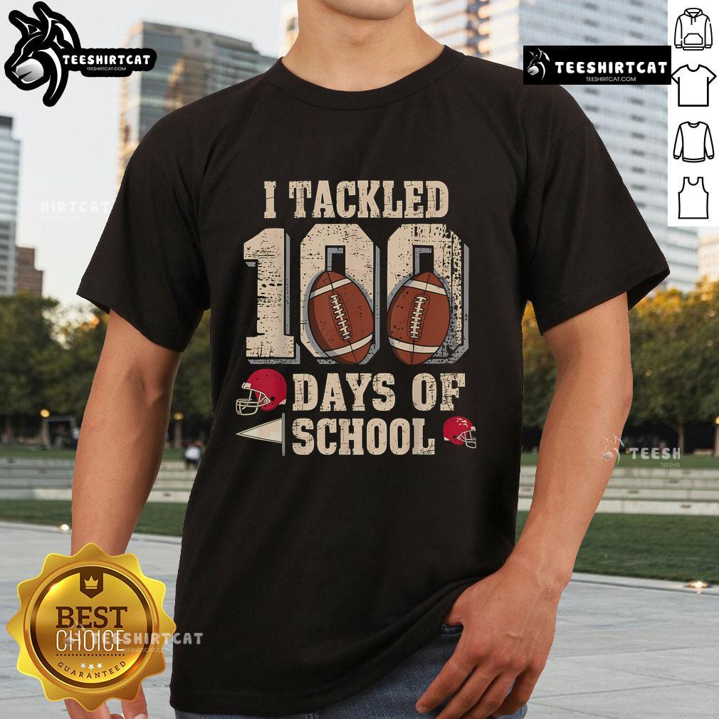 Boy wearing 'Top 100 Days Of School' football t-shirt celebrating 100th day of school with friends in a classroom.