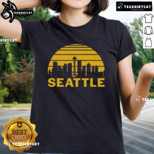 Vintage Seattle cityscape graphic on ladies tee, showcasing iconic skyline and urban charm of Washington.