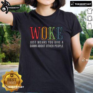Alt Text: Hot Woke Ladies Tee featuring the phrase 'Just Means You Give a Damn About Other People' in bold typography.