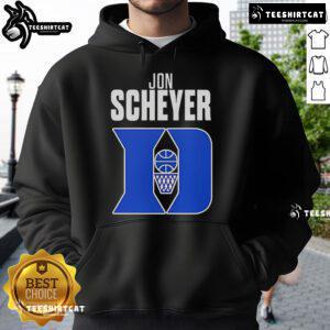 Alt Text: Jon Scheyer, Duke Blue Devils basketball coach, wearing a hoodie, celebrates Coach of the Year award victory.