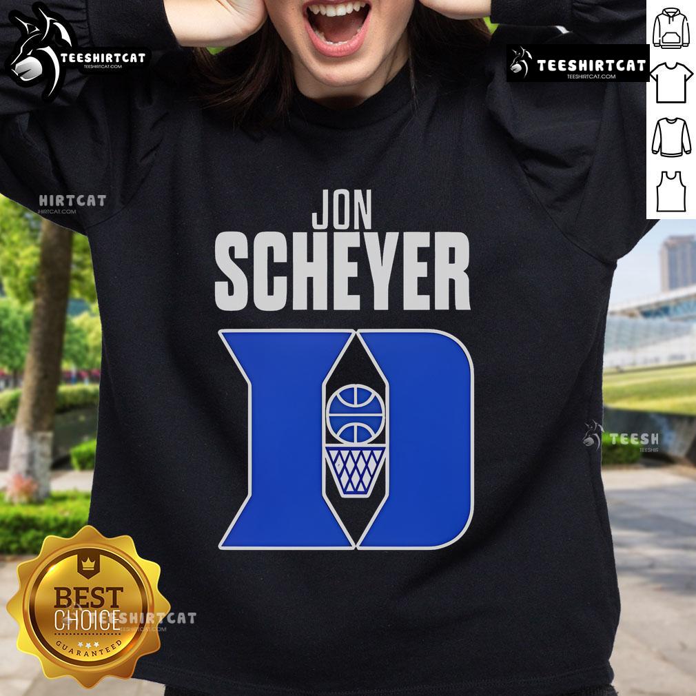 Jon Scheyer wearing a Duke Blue Devils Coach of the Year sweatshirt during a basketball game celebration.