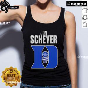 Alt Text: Jon Scheyer, Duke Blue Devils basketball coach of the year, wearing a stylish tank top at a game.