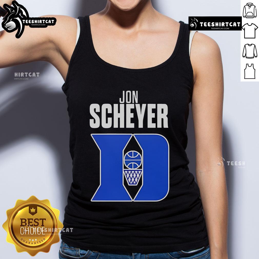 Alt Text: Jon Scheyer, Duke Blue Devils basketball coach of the year, wearing a stylish tank top at a game.