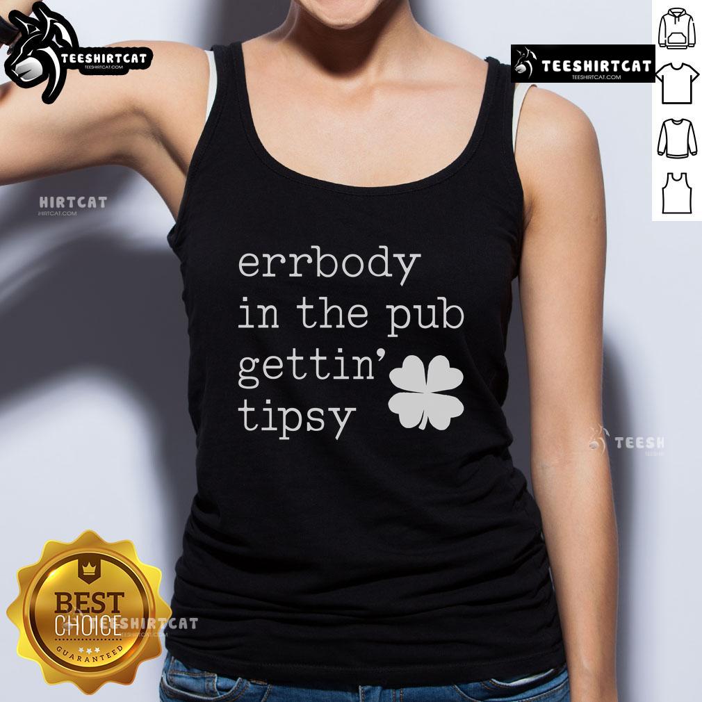 Group of friends in a pub wearing St. Patrick's Day tank tops, enjoying drinks and celebrating together.
