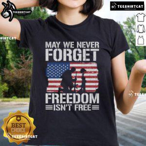Official 'May We Never Forget - Freedom Isn't Free' Ladies Tee featuring patriotic design and comfortable fit.