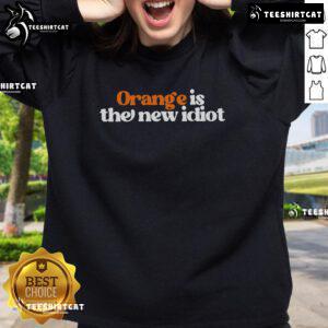 Alt Text: Official Orange Is The New Idiot Sweatshirt featuring bold graphic design, perfect for casual wear and statement pieces.