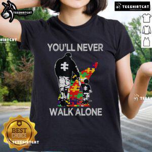 Top Autism Dad Support Alone Puzzle Tee featuring the phrase 'You'll Never Walk Alone' for proud dads of children with autism.