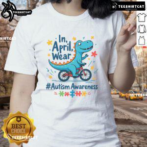 Cute autism awareness dinosaur in April wearing a ladies tee, promoting inclusivity and understanding for autism.