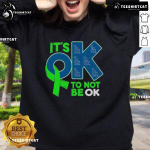 Alt Text: Comfortable Los Angeles Dodgers sweatshirt with 'It's Okay to Not Be Okay' slogan, perfect for fans and casual wear.