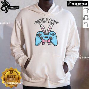 Gamer in a hoodie with 'I Paused My Game to Hunt Eggs' design, perfect for Easter gaming enthusiasts.