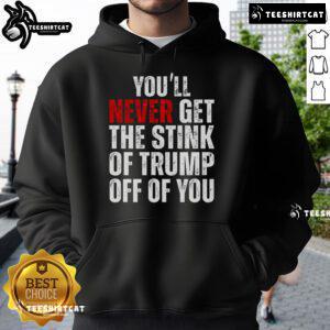 Trendy hoodie featuring 'You'll Never Get The Stink Of Trump Off Of You' slogan, perfect for expressing political humor.