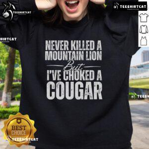 Alt Text: Official Never Killed A Mountain Lion But I've Choked A Cougar Sweatshirt in stylish design, perfect for animal lovers.