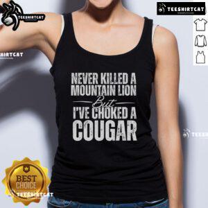 Official Never Killed A Mountain Lion But I've Choked A Cougar Tank Top design featuring bold text and graphic elements.