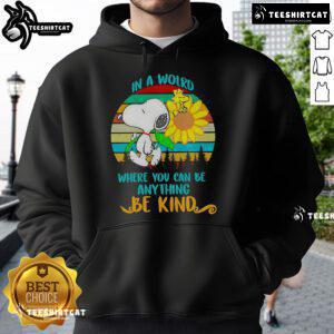 Happy Snoopy in a sunflower design on a retro hoodie with the quote 'In a world where you can be anything, be kind.'